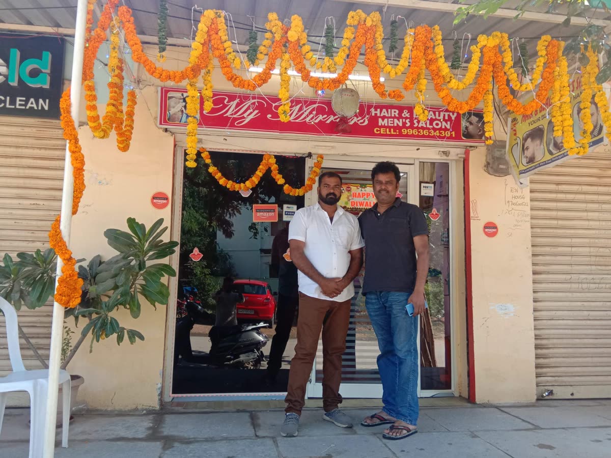 The Hyderabad branch's owners outside the shop, decorated for Diwali